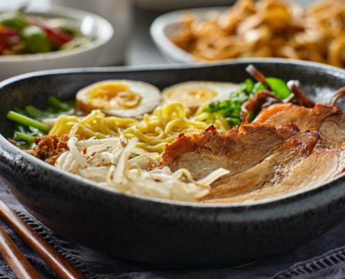 japanese tonkotsu ramen bowl on dinner table at restaurant