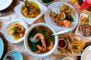 Deep-fried eggplant, Tuna Steak and Steamed Shrimp dishes on the table, Philippines Filipino Food
