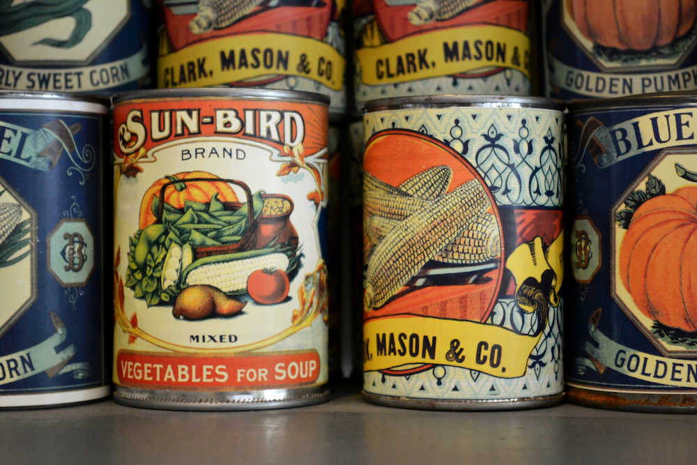Largo, United States - November 9, 2011: Stacked canned vegetables on the shelves of a General Store in Heritage Village from the 1900s with colorful labels featuring Sun-Bird and Mason Company products. Heritage Village located in Florida recreates the history with relocated buildings staged with products and goods from the early 1900s era.