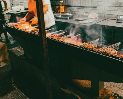 Chinese BBQ Skewers grilling over open flames