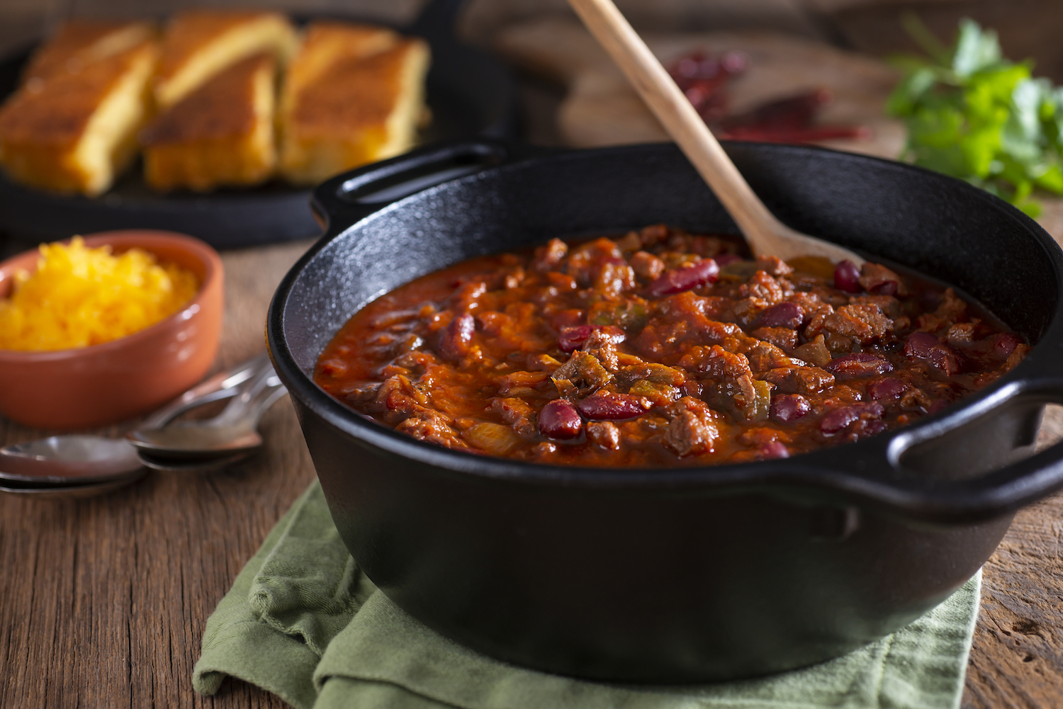 Classic Southwestern Chili in a Cast Iron Dutch Oven with Corn Bread and Cheddar Cheese