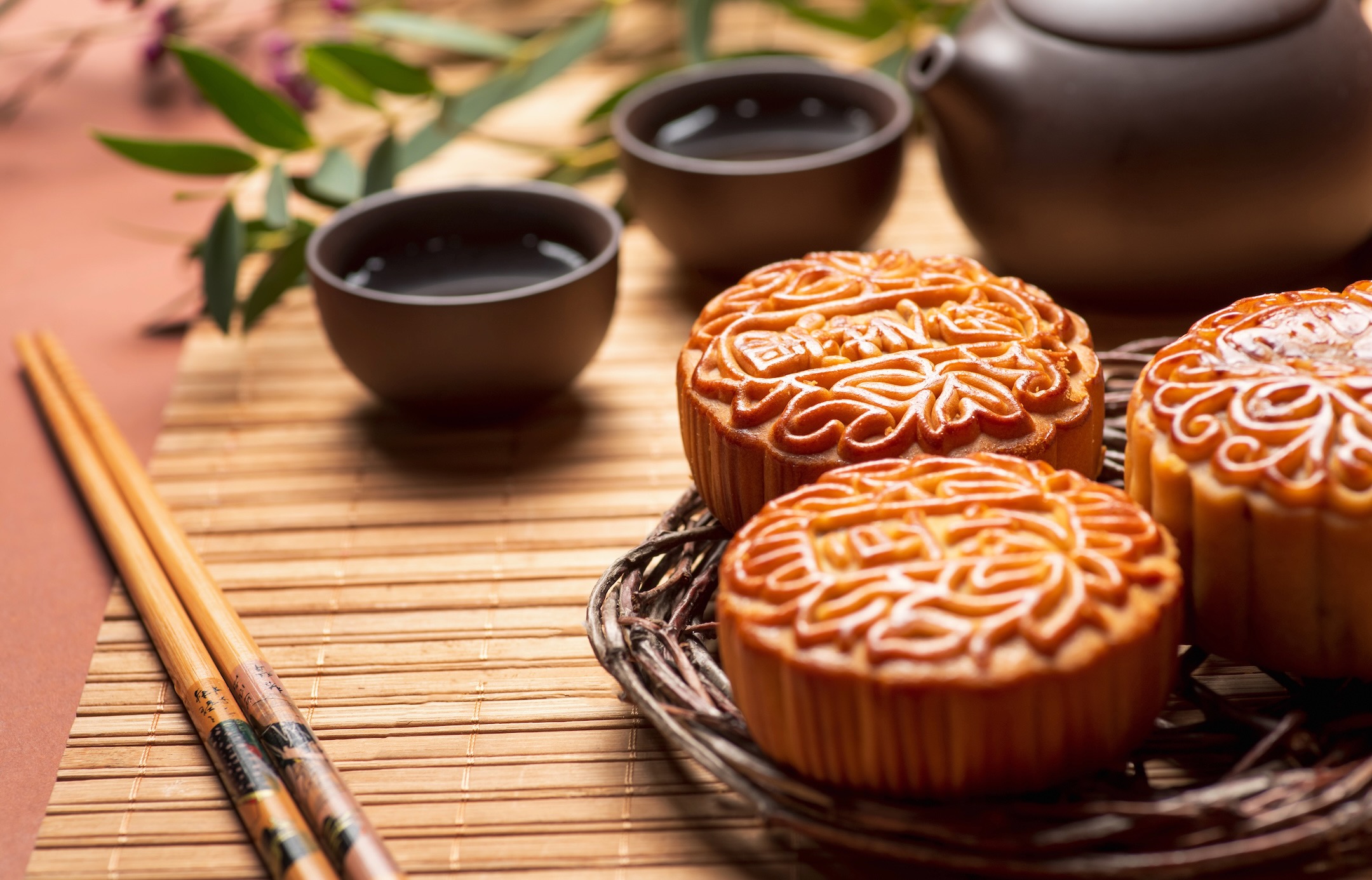 Mooncake traditional Chinese pastry served for Mid Autumn day festival with herbal tea and with various staffing. Tradition and holiday in China and parts of East Asia
