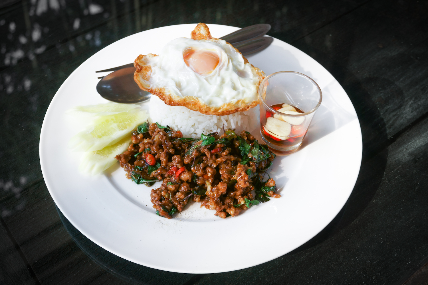 Thai stir-fried pork and fried egg and basil served with rice,Fried Basil with Pork Chop