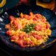 Stir fried tomato and eggs in blue dish