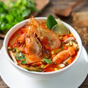 Tom Yam Kung ,Prawn and lemon soup with mushrooms, thai food in wooden bowl top view