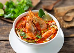 Tom Yam Kung ,Prawn and lemon soup with mushrooms, thai food in wooden bowl top view