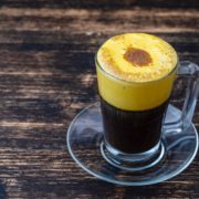 Traditional vietnamese egg coffee made of raw egg yolk and condensed milk, close up. Eggcoffee on wooden table background on our blog stories
