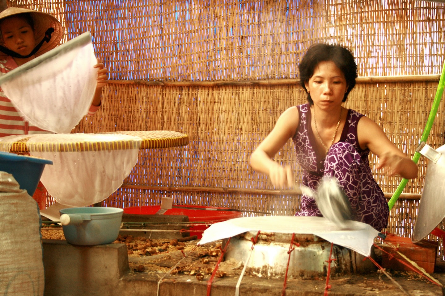 Mekong Delta, Vietnam - July 19, 2009: A Vietnamese woman is cooking rice paper in a village Vietnamese Pantry Staples